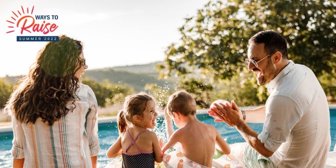 Parents with young son and daughter splashing in the pool