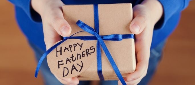 child holds a fathers day gift for his dad (1)