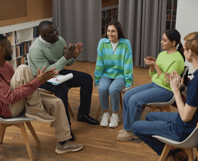 Local community group members sitting in a roundtable conversation