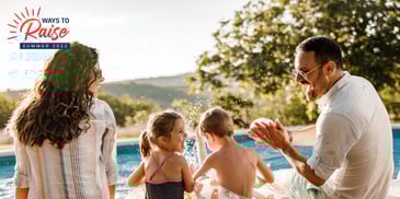 Parents with two young children sitting next to pool