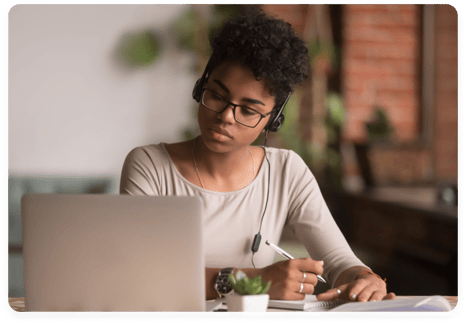 Private school student studying with laptop and headphones