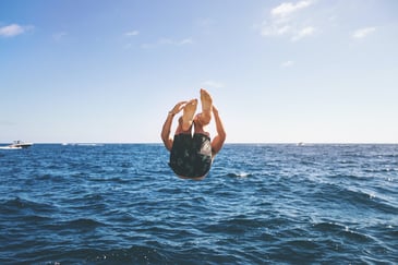 man diving and plunging into water