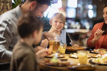 family dining at a restaurant night fundraiser