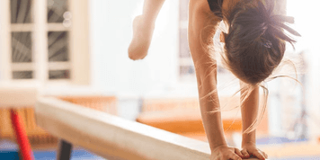 Young gymnast on a balance beam