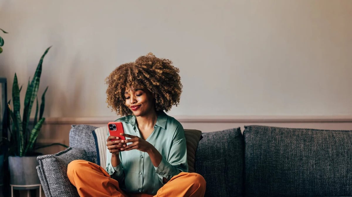 woman who is relaxed and browsing her mobile phone