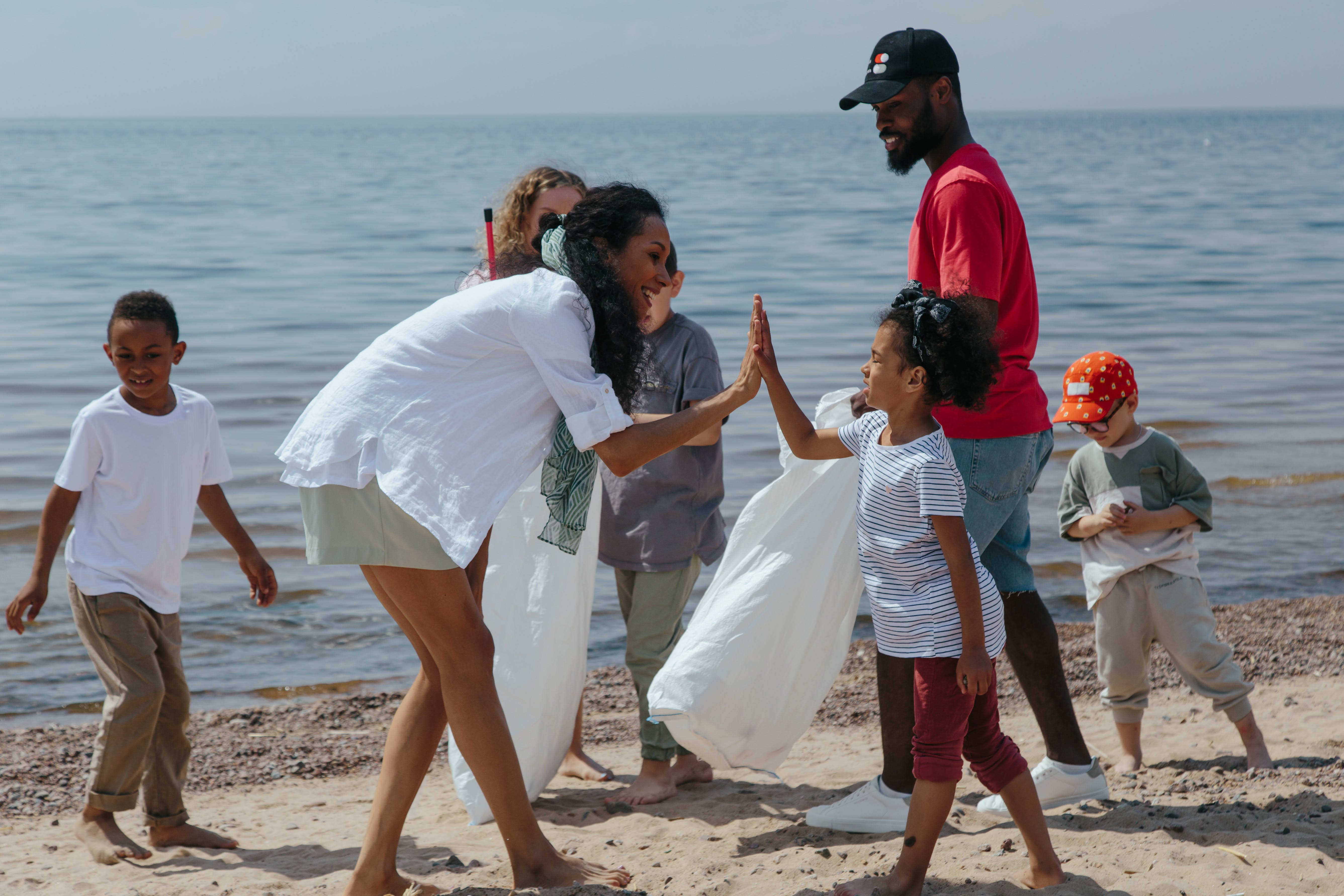 family doing a beach cleanup for random acts of kindness week