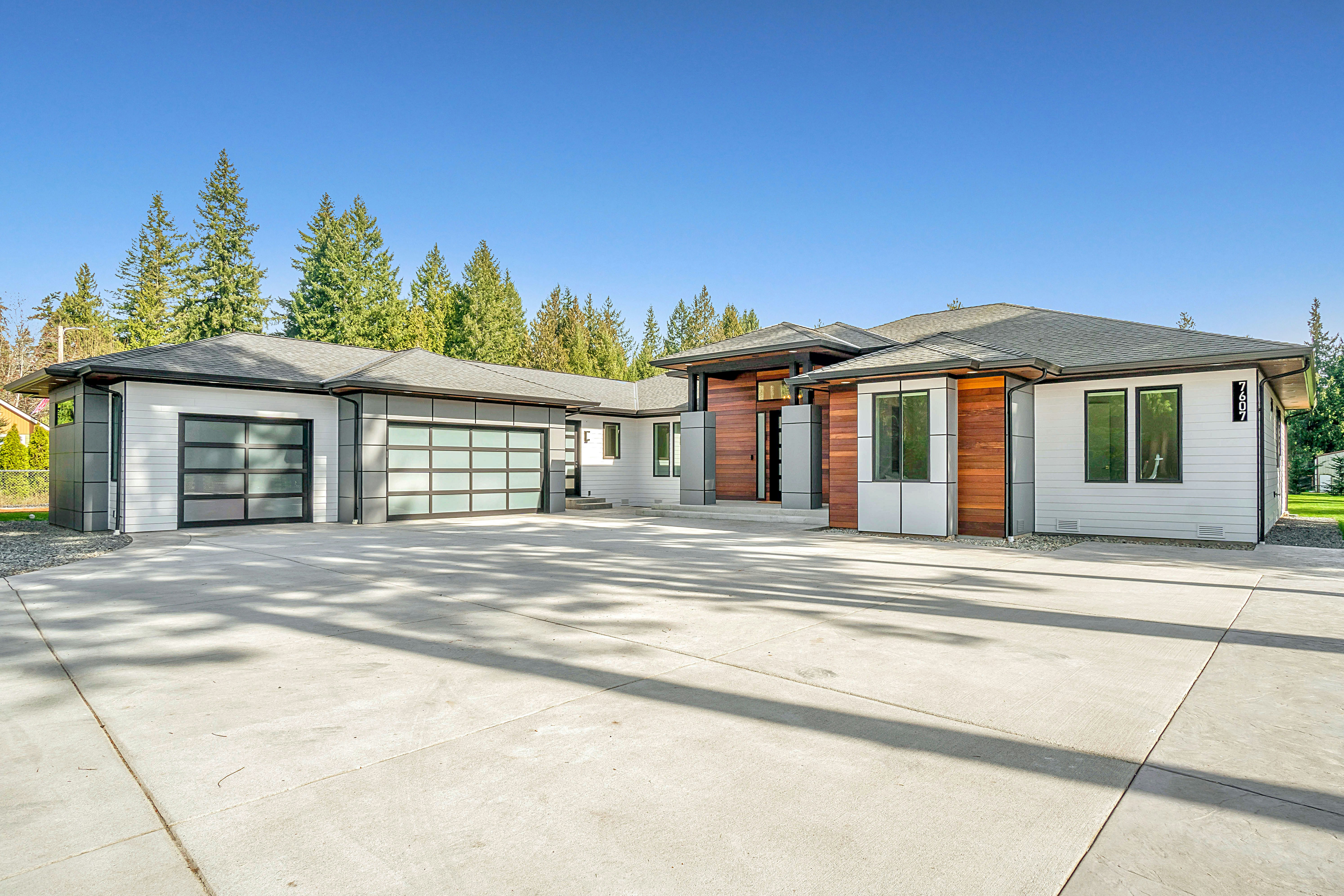 exterior of a single story home with updated garage and house numbers