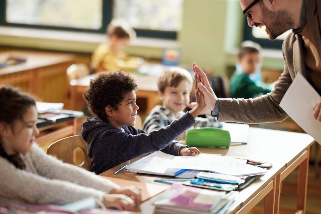teacher giving student a high five