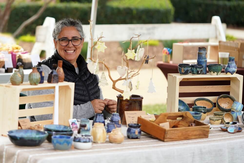 woman selling crafts at a craft fair fundraiser