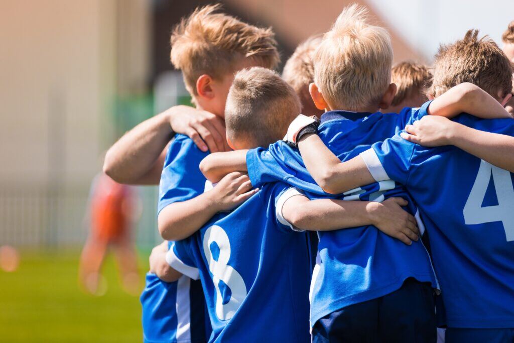 youth soccer team gathered in a huddle