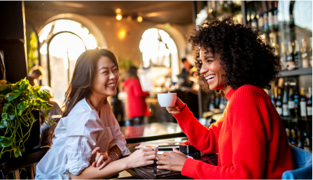 two women having a conversation over coffee