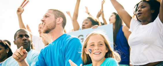 Fans cheering at a school sporting event