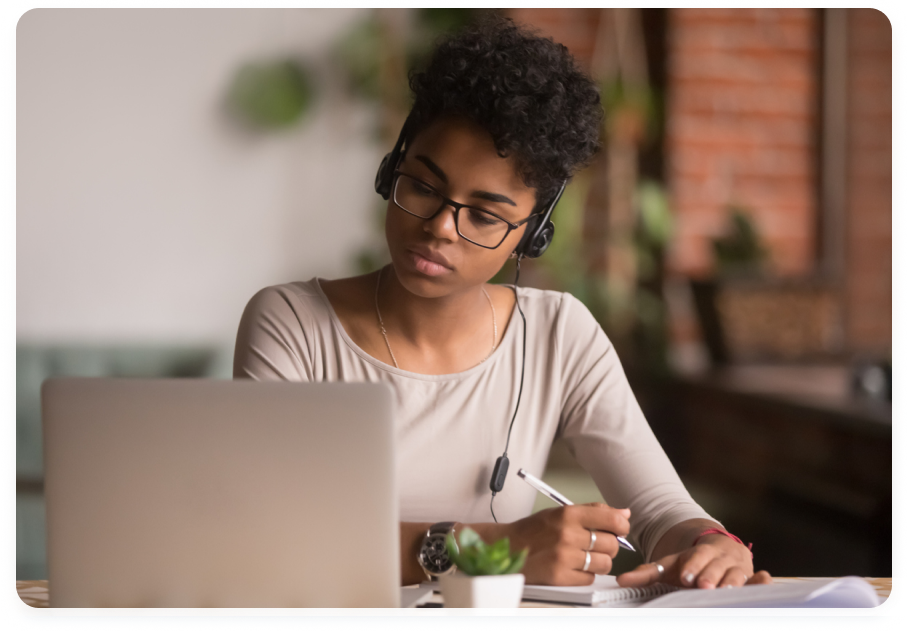 Private school student studying with laptop and headphones