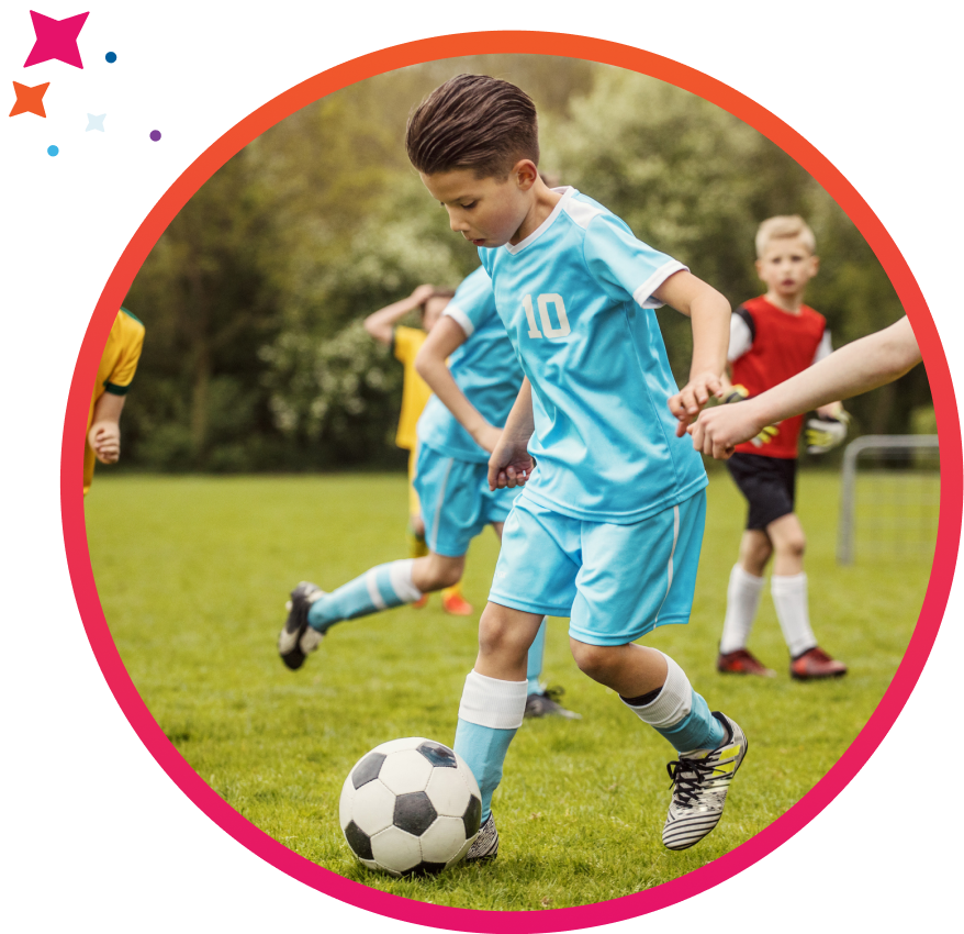 Youth soccer player running with the ball